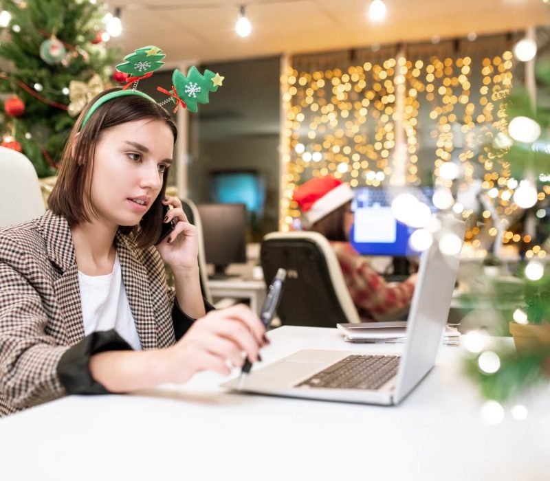 young-contemporary-businesswoman-with-mobile-phone-organizing-work-in-office